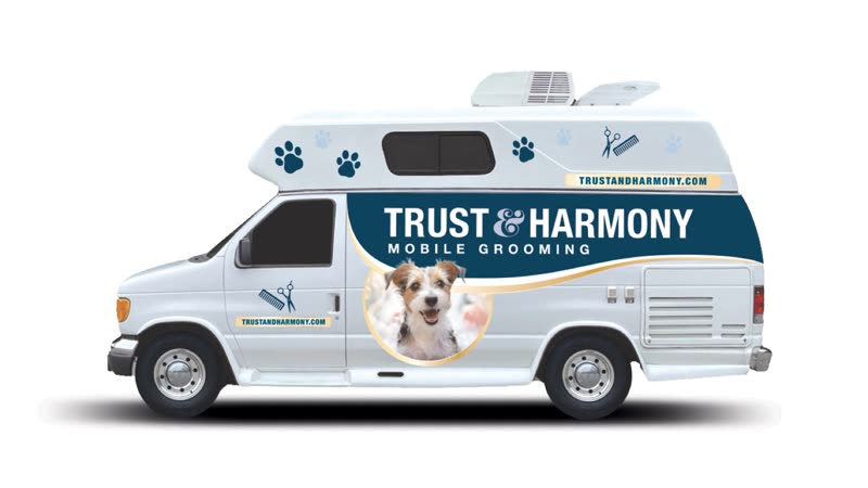 The mobile grooming van parked kerbside, seen from the side